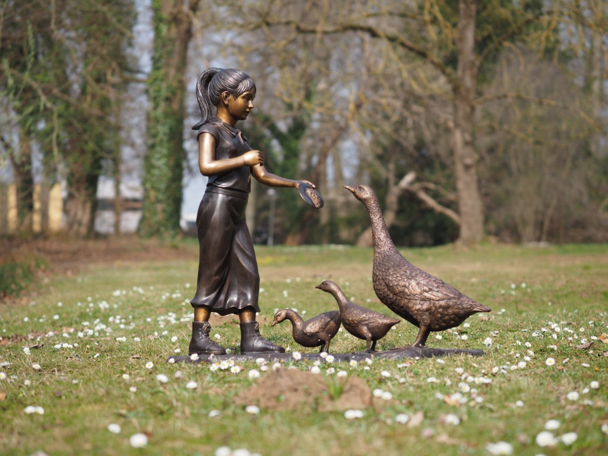 Girl feeding geese
