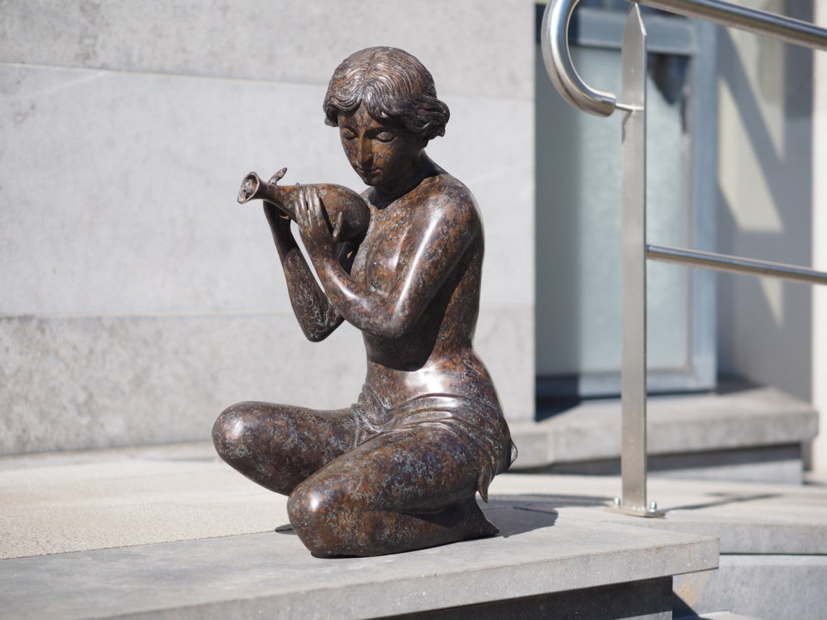 Kneeling woman pouring water (fountain)