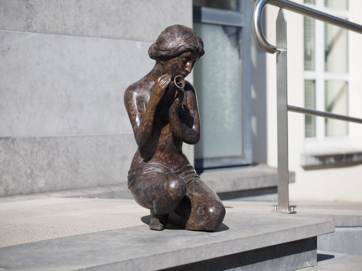 Kneeling woman pouring water (fountain)