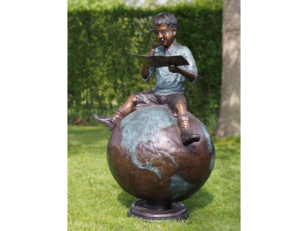 Boy Sitting On Globe