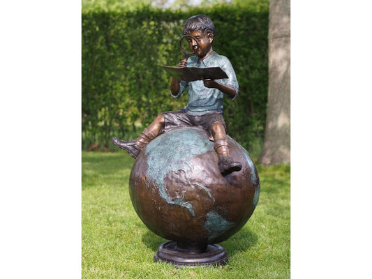 Boy Sitting On Globe